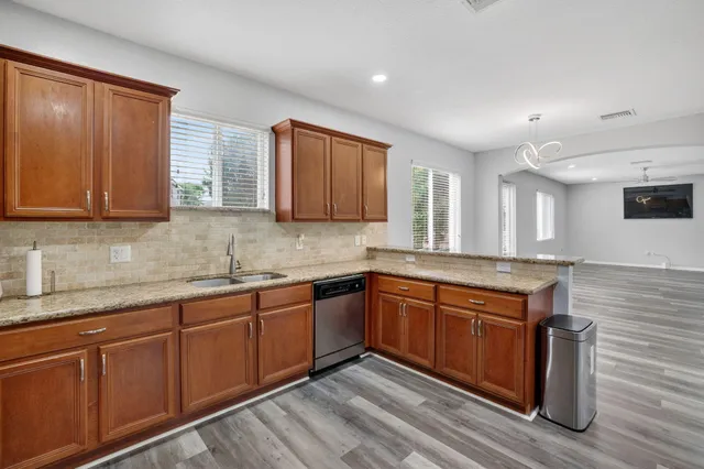 a bedroom with a bed and a chandelier fan
