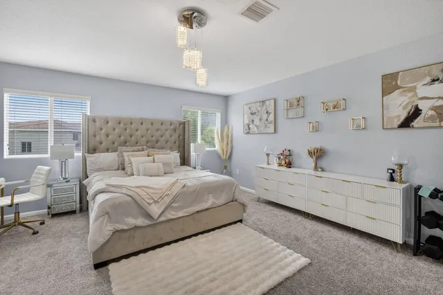 a bedroom with a bed and a flat tv screen