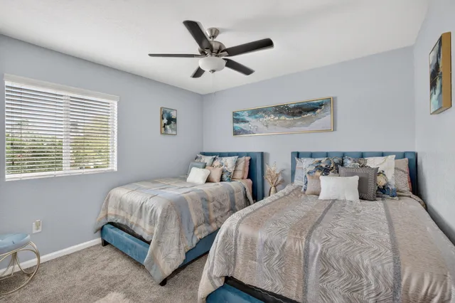 a view of a house with a yard and table and chair under an umbrella