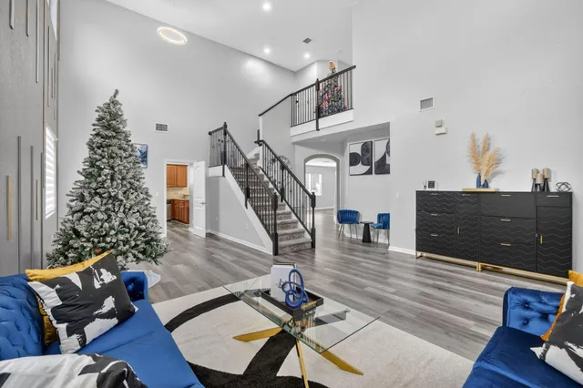 a view of a livingroom with wooden floor and a flat screen tv