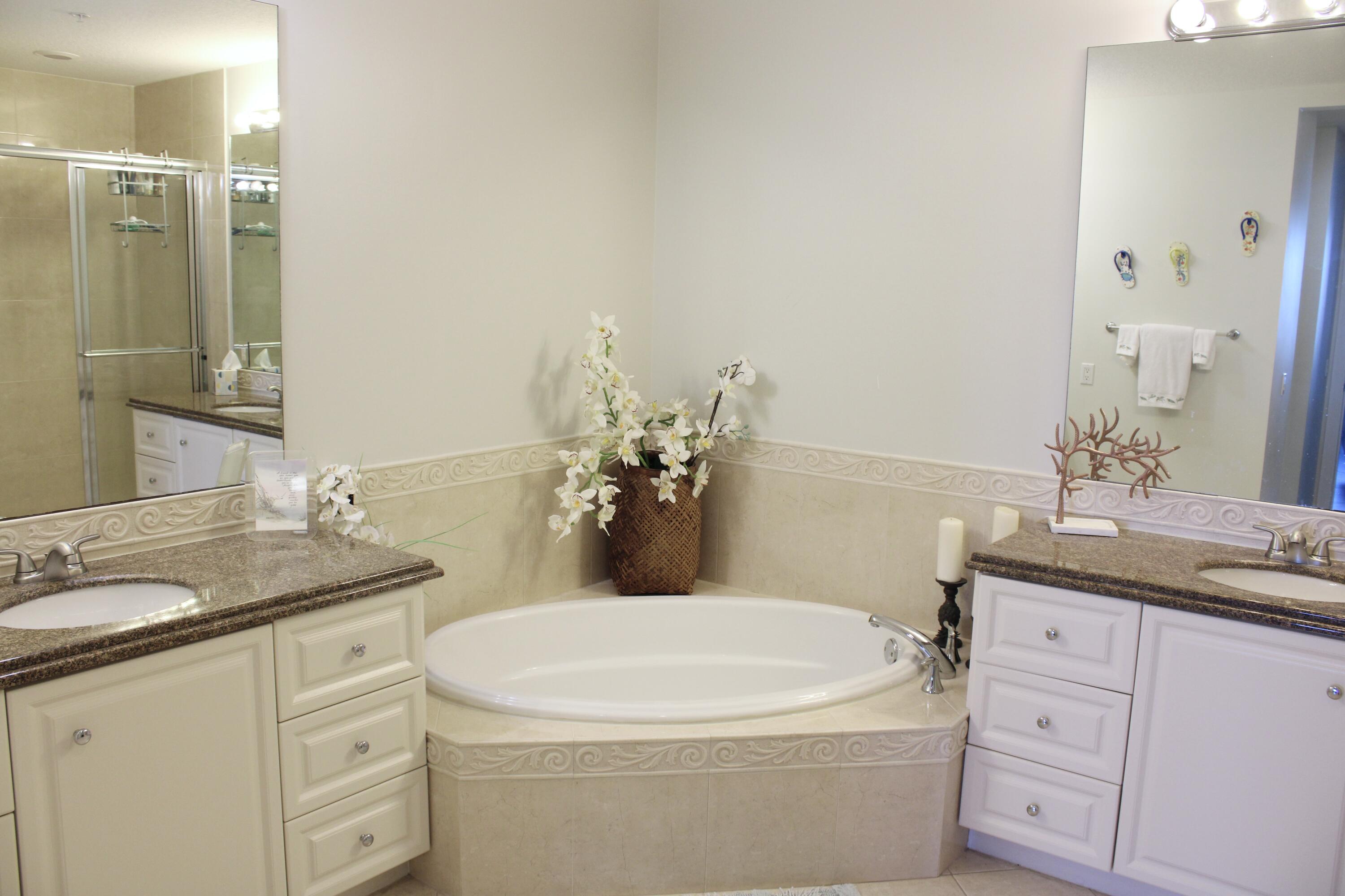 3 Harbour Isle Drive East, Unit 204 Fort Pierce, FL 34949 - Photo 13 of 21 a bathroom with a granite countertop sink and a mirror