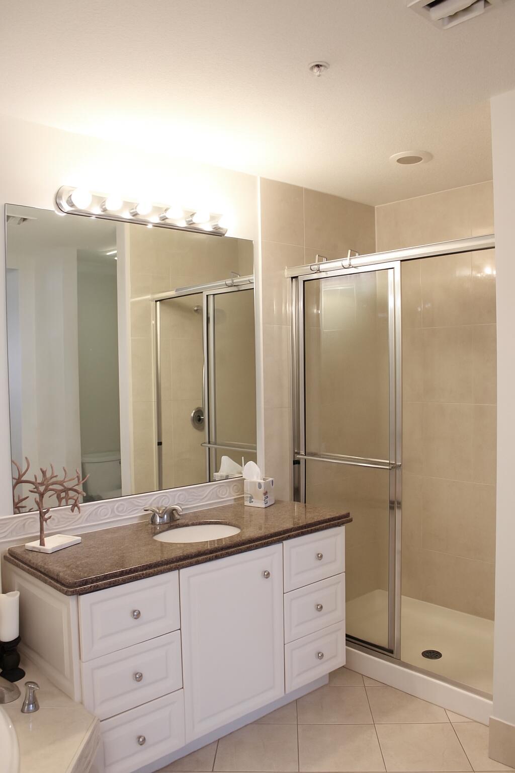 3 Harbour Isle Drive East, Unit 204 Fort Pierce, FL 34949 - Photo 14 of 21 a bathroom with a granite countertop sink mirror and double