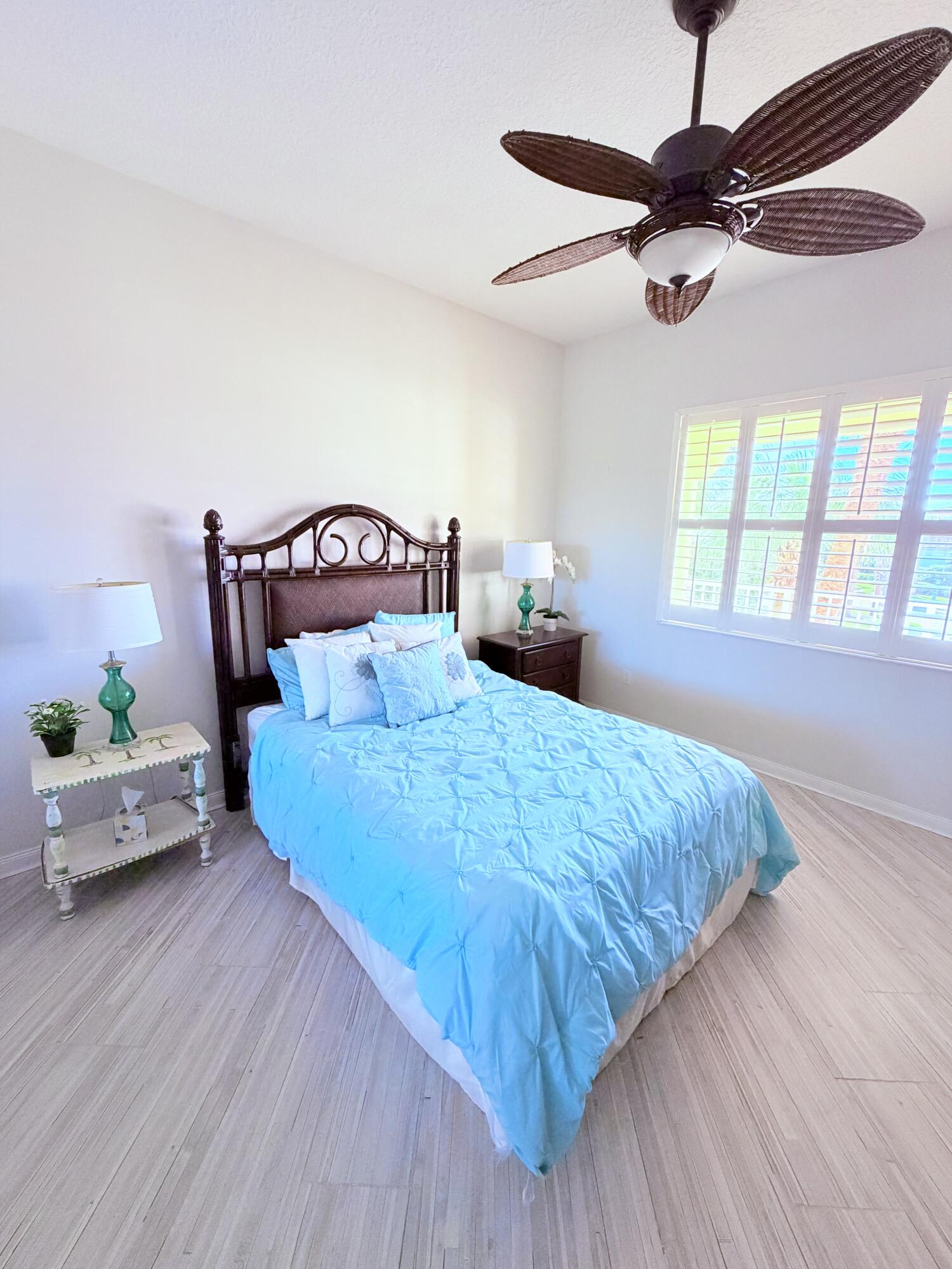 3 Harbour Isle Drive East, Unit 204 Fort Pierce, FL 34949 - Photo 15 of 21 a bedroom with a bed and wooden floor