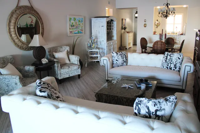 a living room with furniture and a mirror