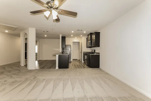 a view of a kitchen with a sink and a refrigerator