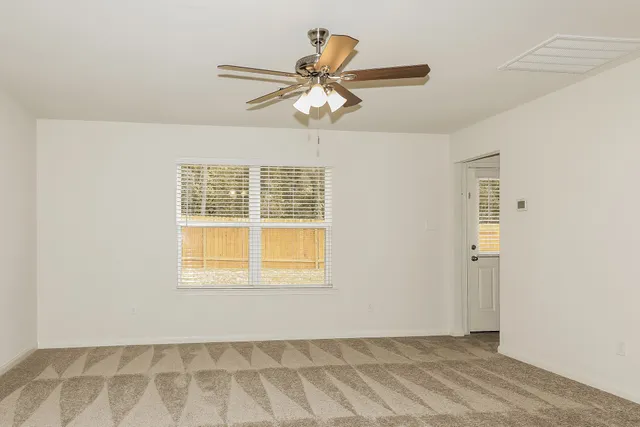 a view of an empty room with a window