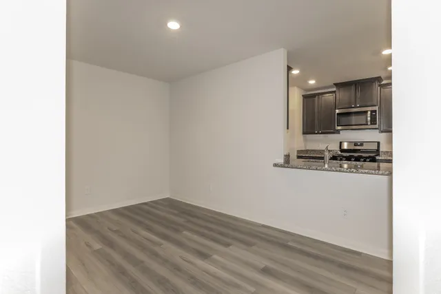 a kitchen with stainless steel appliances granite countertop a stove a sink and a refrigerator