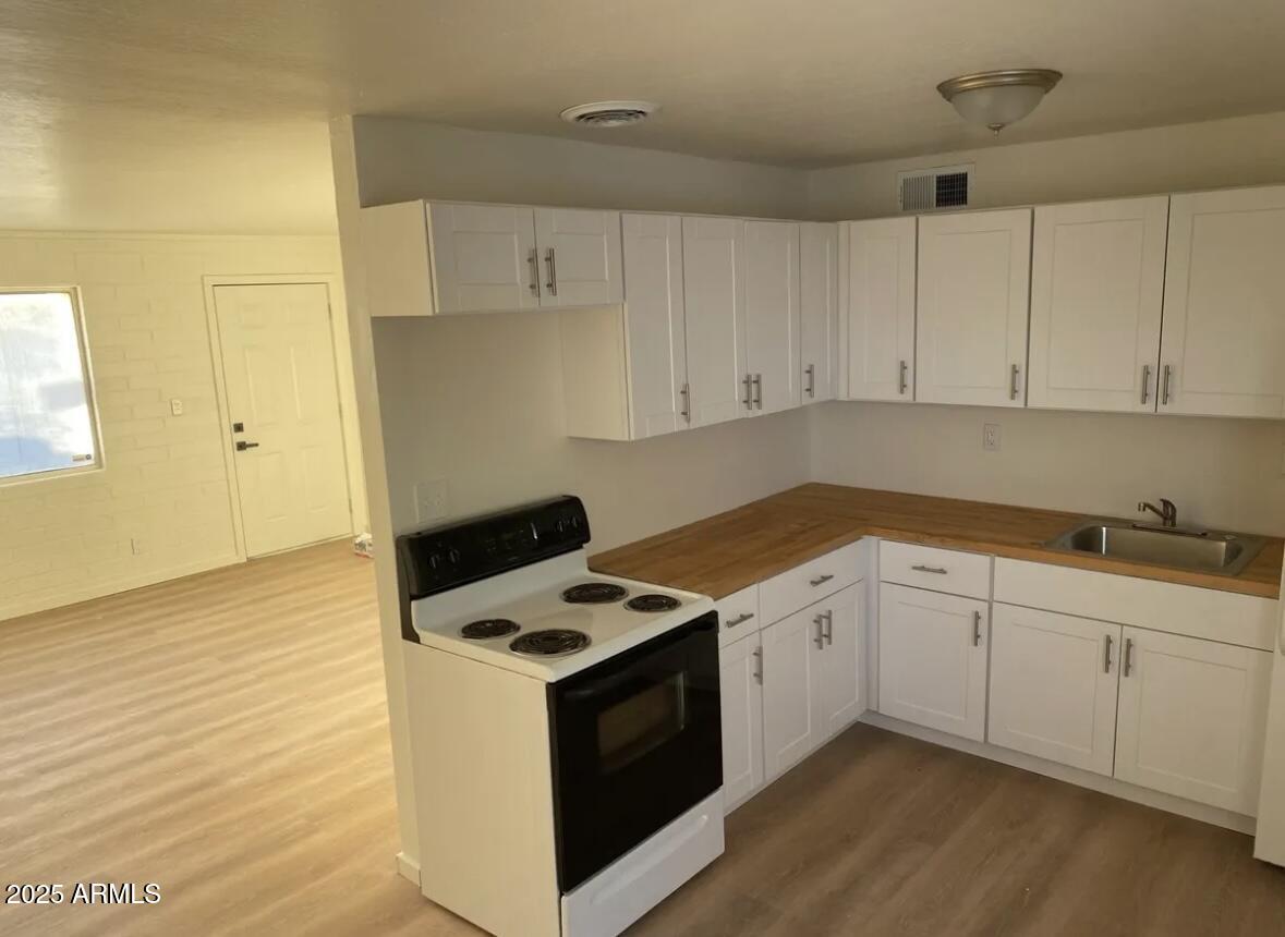 704 West 11th Street Casa Grande, AZ 85122 - Photo 2 of 10 a kitchen with granite countertop white cabinets and white appliances