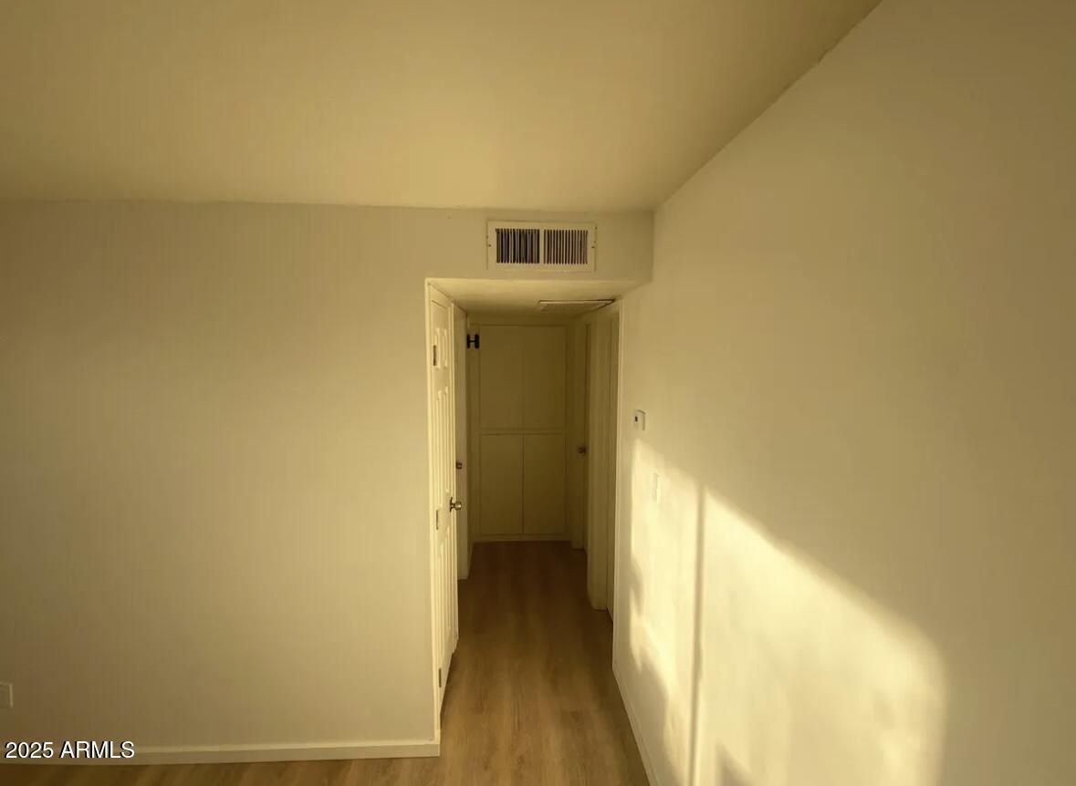 704 West 11th Street Casa Grande, AZ 85122 - Photo 8 of 10 a view of a hallway with wooden floor
