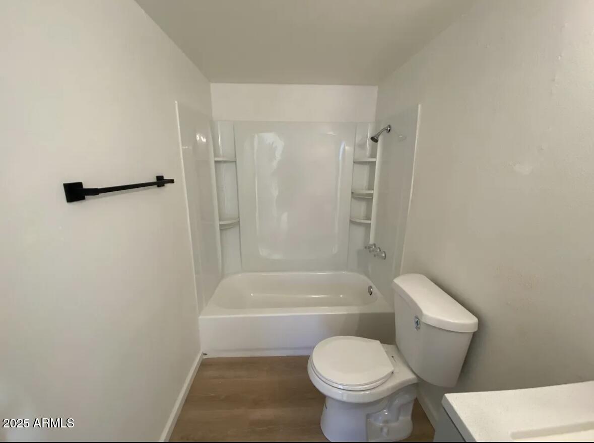 704 West 11th Street Casa Grande, AZ 85122 - Photo 10 of 10 a white toilet sitting next to a bath tub