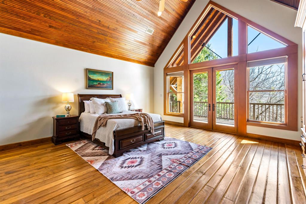 9930 Boat Club Road Fort Worth, TX 76179 - Photo 37 of 40 Hill Lodge’s bedroom 3 of 3 features soaring wood ceilings, custom built-ins, and large windows that fill the space with natural light.