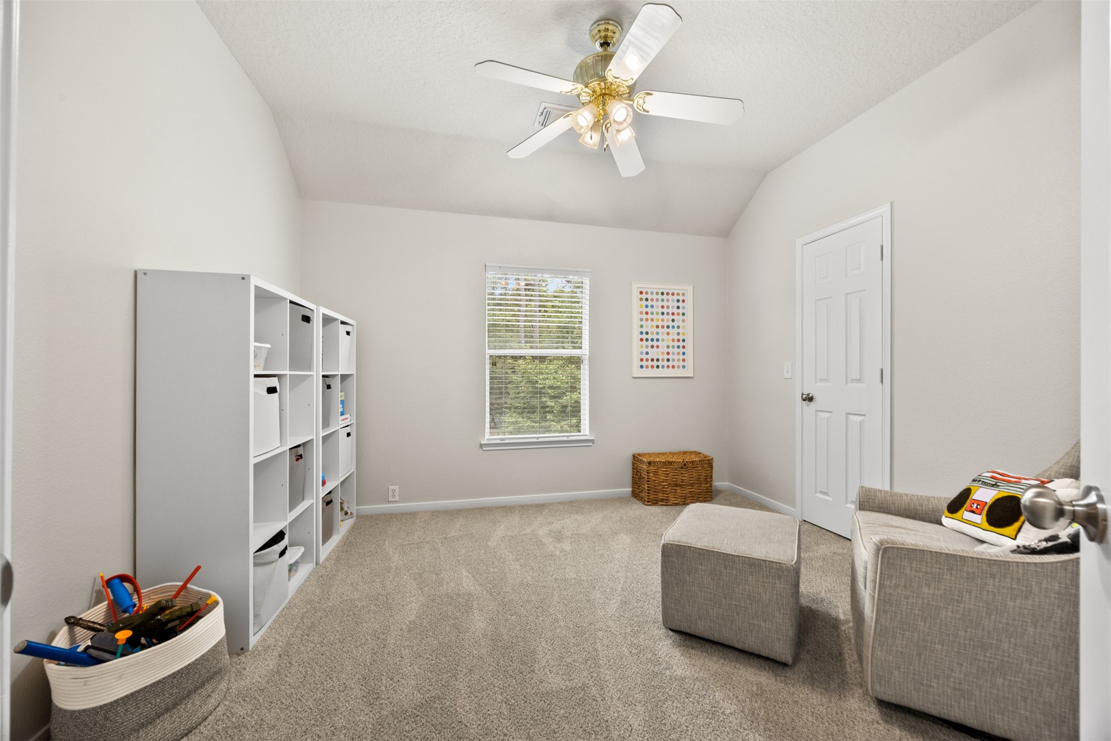 2219 Louetta Brook Lane Spring, TX 77388 - Photo 31 of 34 Bright secondary bedroom with vaulted ceiling, plush carpeting, and flexible layout—perfect for a bedroom, playroom, or home office.