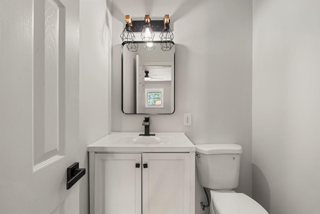 2312 Burnside Drive Columbus, GA 31907 - Photo 11 of 25 a bathroom with a toilet sink and mirror