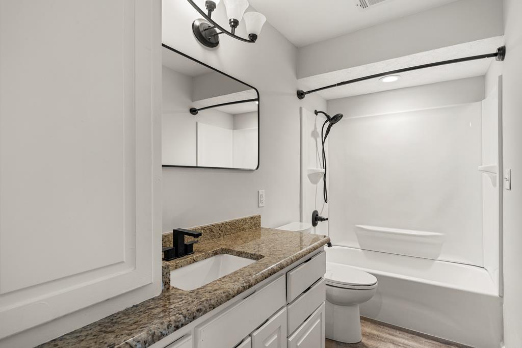 2312 Burnside Drive Columbus, GA 31907 - Photo 15 of 25 a bathroom with a granite countertop sink toilet and shower