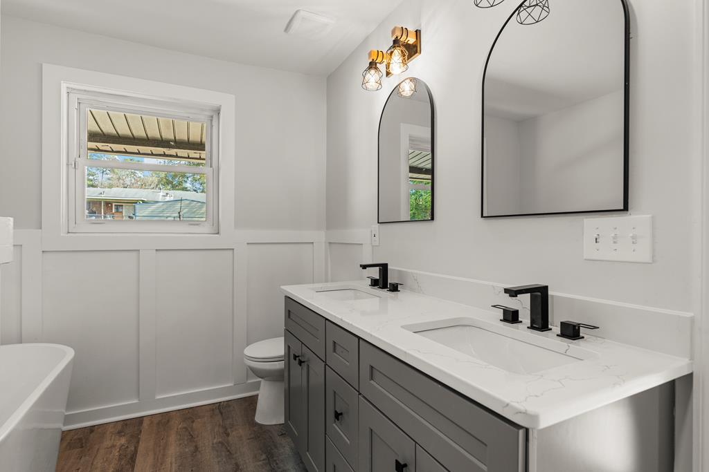 2312 Burnside Drive Columbus, GA 31907 - Photo 19 of 25 a bathroom with a sink a toilet and a mirror