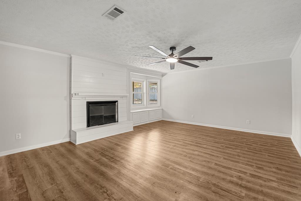2312 Burnside Drive Columbus, GA 31907 - Photo 3 of 25 wooden floor in an empty room with a fireplace