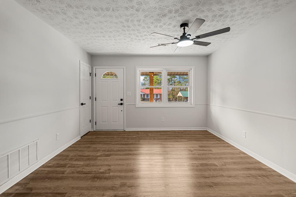 2312 Burnside Drive Columbus, GA 31907 - Photo 5 of 25 a view of a hallway with wooden floor and a window