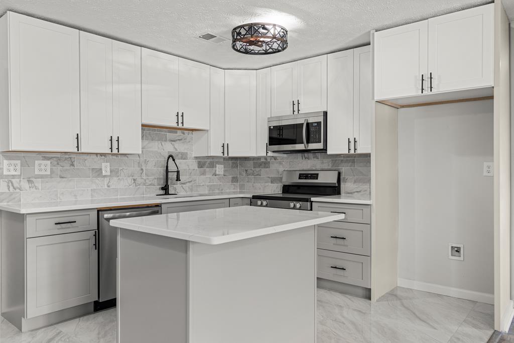 2312 Burnside Drive Columbus, GA 31907 - Photo 7 of 25 a kitchen with cabinets appliances a sink and a counter top space