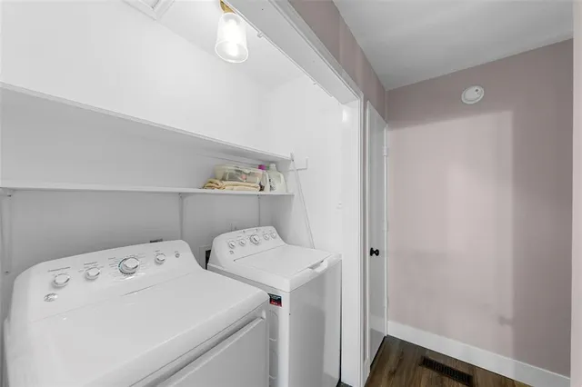 a bedroom with double vanity and a mirror