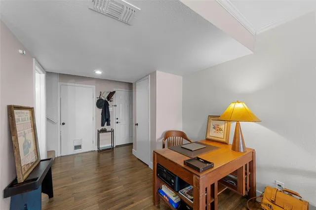 a living room with furniture a flat screen tv and wooden floor