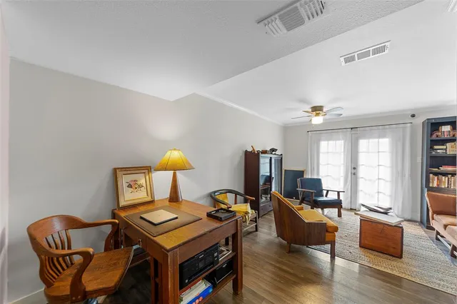 a living room with furniture a ceiling fan and a window
