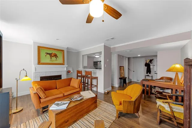 a living room with furniture and wooden floor