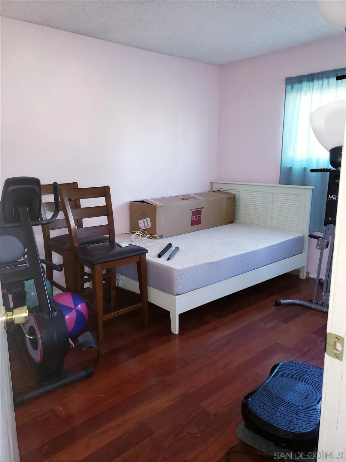 1704 Rees Road San Marcos, CA 92069 - Photo 3 of 6 a bedroom with a bed and a potted plant on dresser