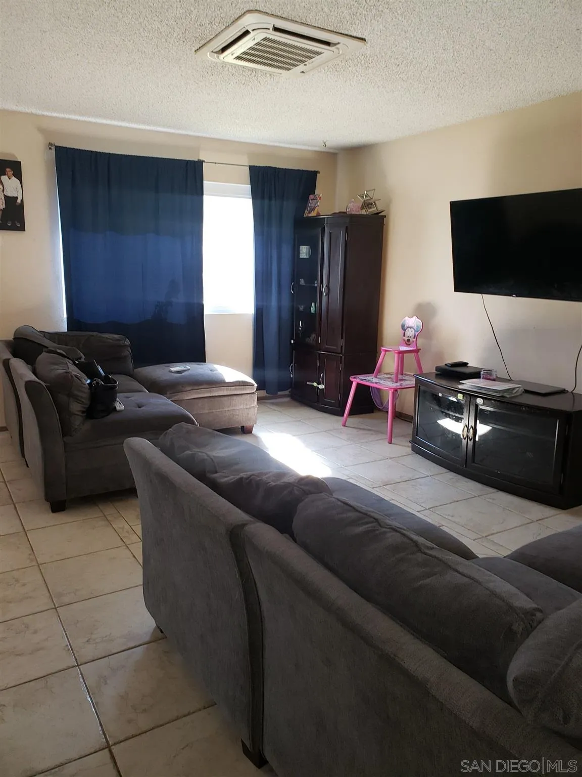 1704 Rees Road San Marcos, CA 92069 - Photo 6 of 6 a living room with furniture and a flat screen tv