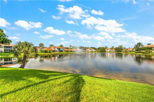 a view of a lake with houses in the background