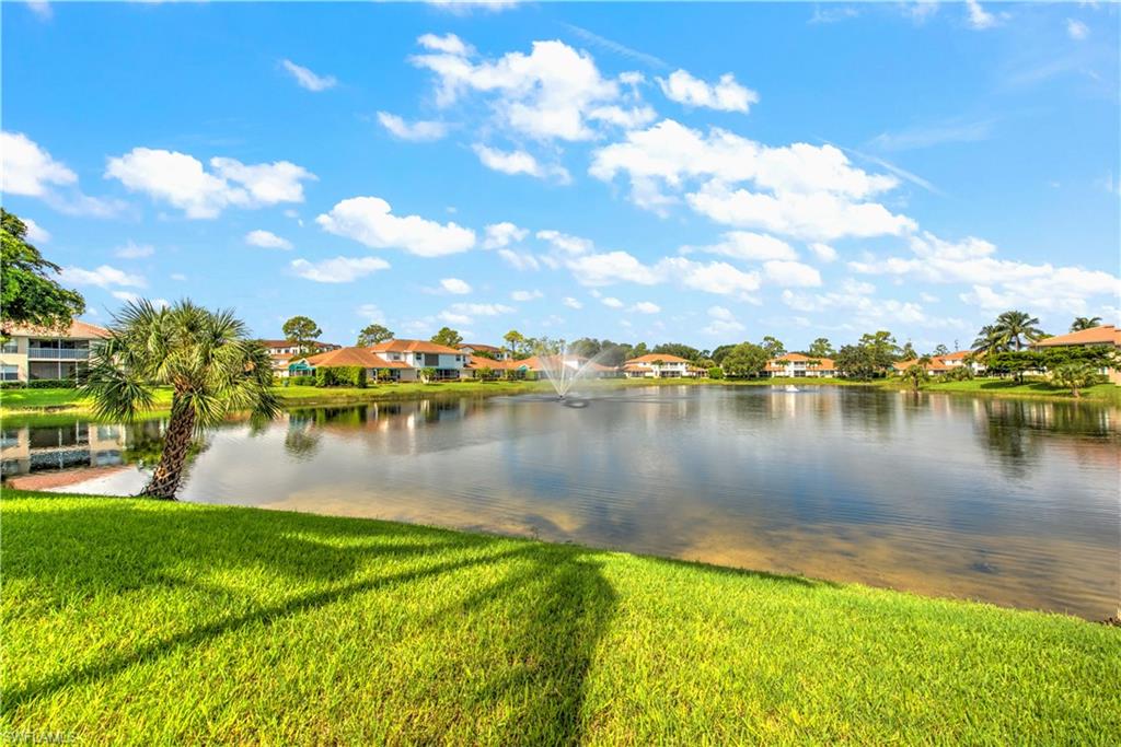 343 Dover Place, Unit A104 Naples, FL 34104 - Photo 11 of 36 a view of a lake with houses in the background