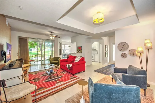 a living room with furniture and a chandelier