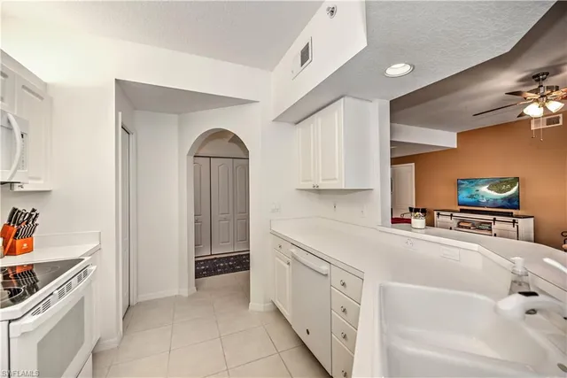 a kitchen with stainless steel appliances a sink and cabinets