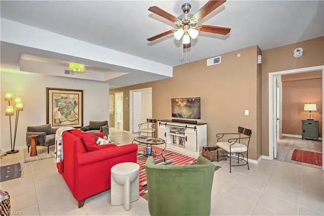 a living room with furniture a chandelier and a flat screen tv