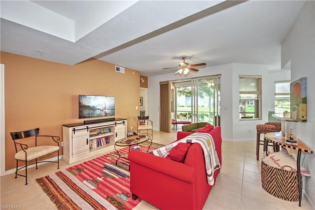 343 Dover Place, Unit A104 Naples, FL 34104 - Photo 2 of 36 a living room with furniture and a flat screen tv