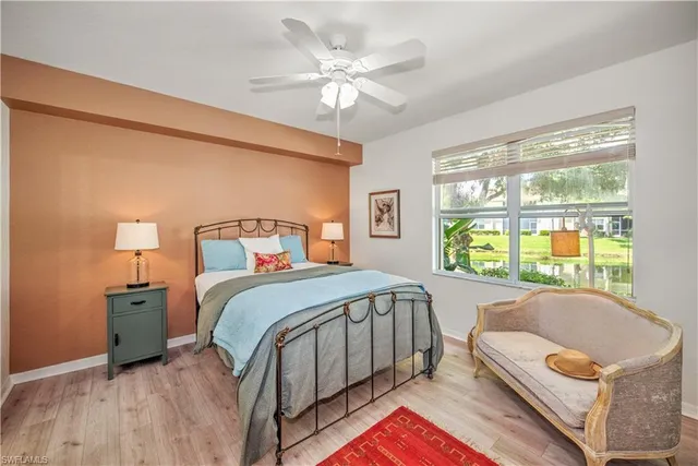 a bedroom with a bed and a large window with outer view