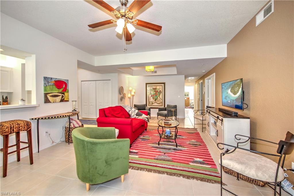 343 Dover Place, Unit A104 Naples, FL 34104 - Photo 26 of 36 a living room with furniture and a window