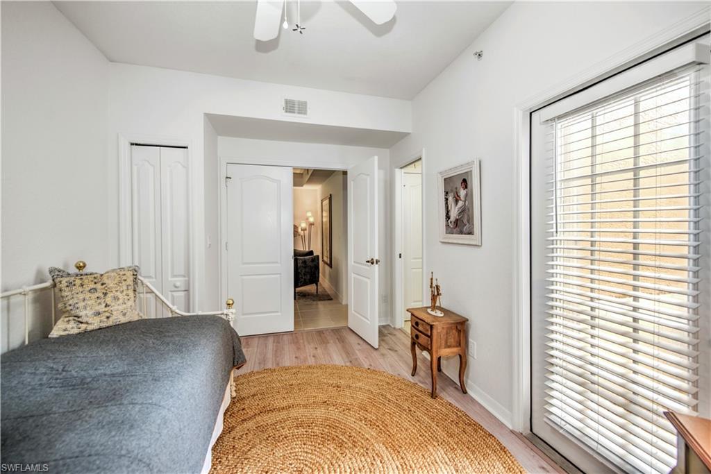 343 Dover Place, Unit A104 Naples, FL 34104 - Photo 31 of 36 a bedroom with furniture and a window