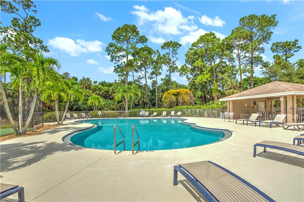 343 Dover Place, Unit A104 Naples, FL 34104 - Photo 33 of 36 a view of a swimming pool with lounge chairs