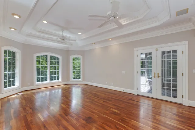 a spacious bedroom with a large bed and a large window
