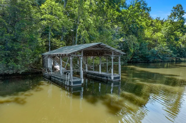 a view of a wooden deck with lake view