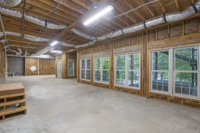 a room with pool table and windows