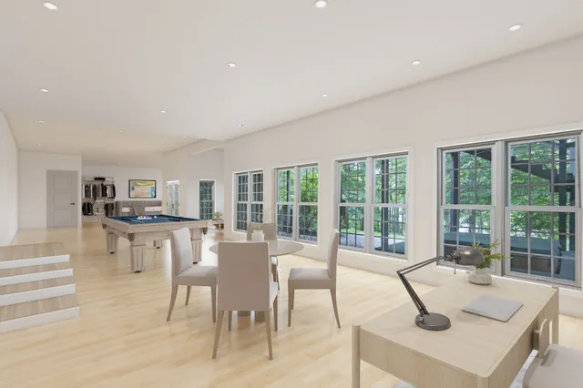 a room with pool table and windows
