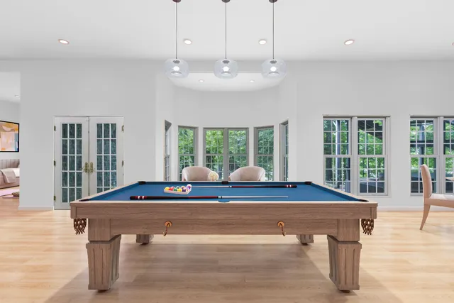 a bedroom with furniture and a wooden floor
