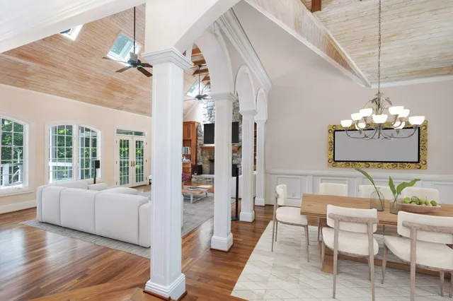 a living room with furniture and a chandelier