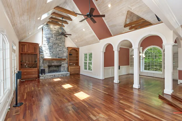 a living room with furniture a fireplace and a flat screen tv