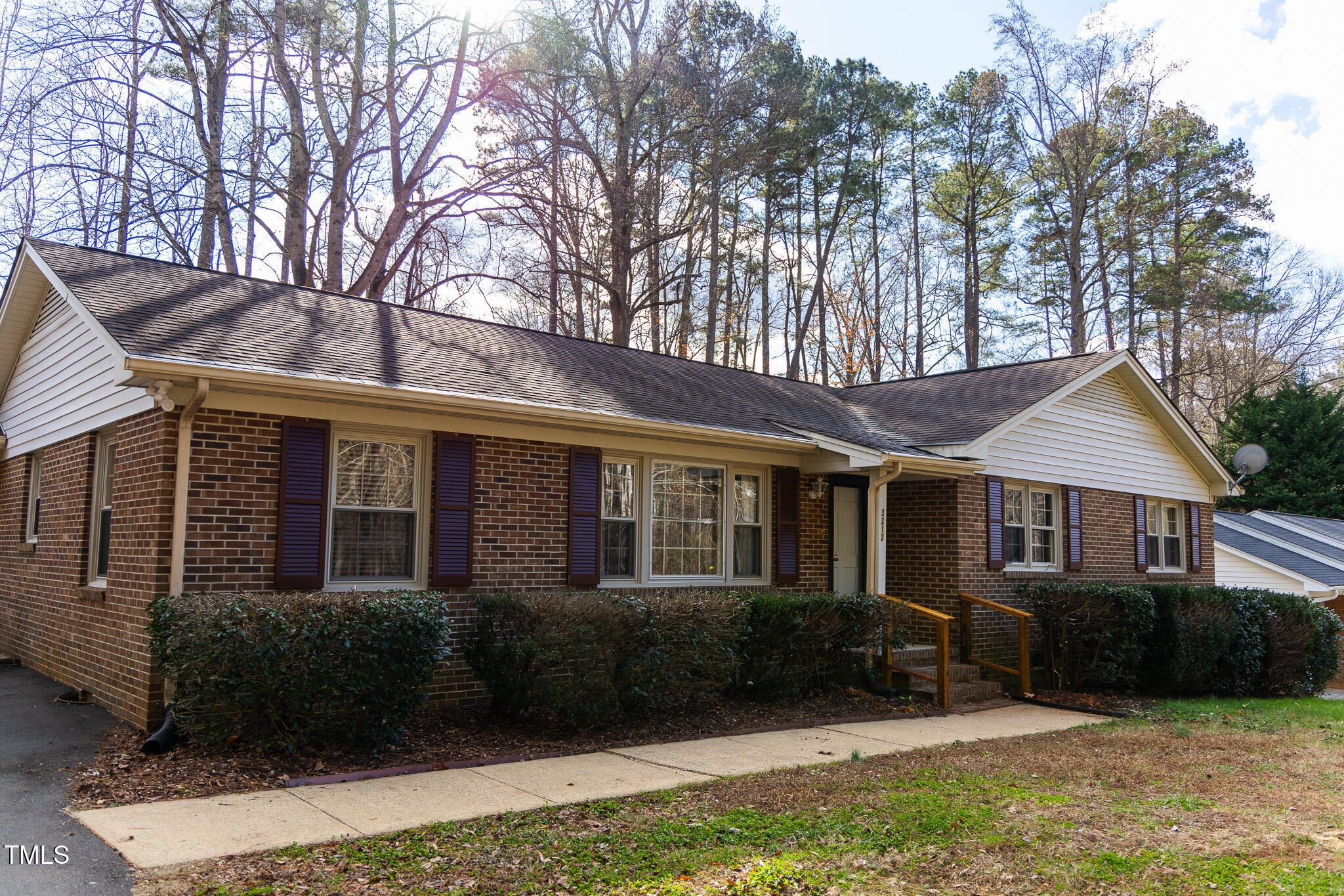 a front view of a house with a yard and outdoor seating