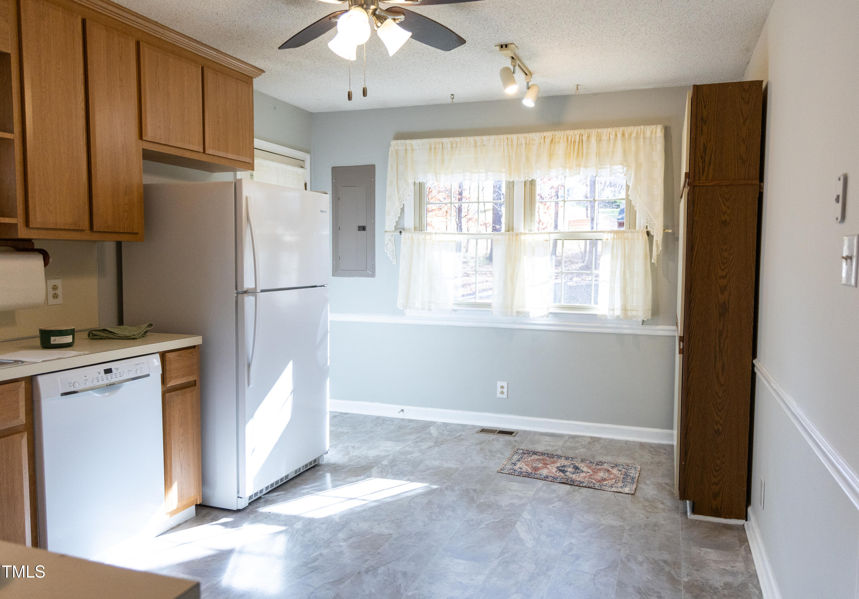 3212 Sparger Road Durham, NC 27705 - Photo 13 of 57 a kitchen with a refrigerator a stove a sink and cabinets