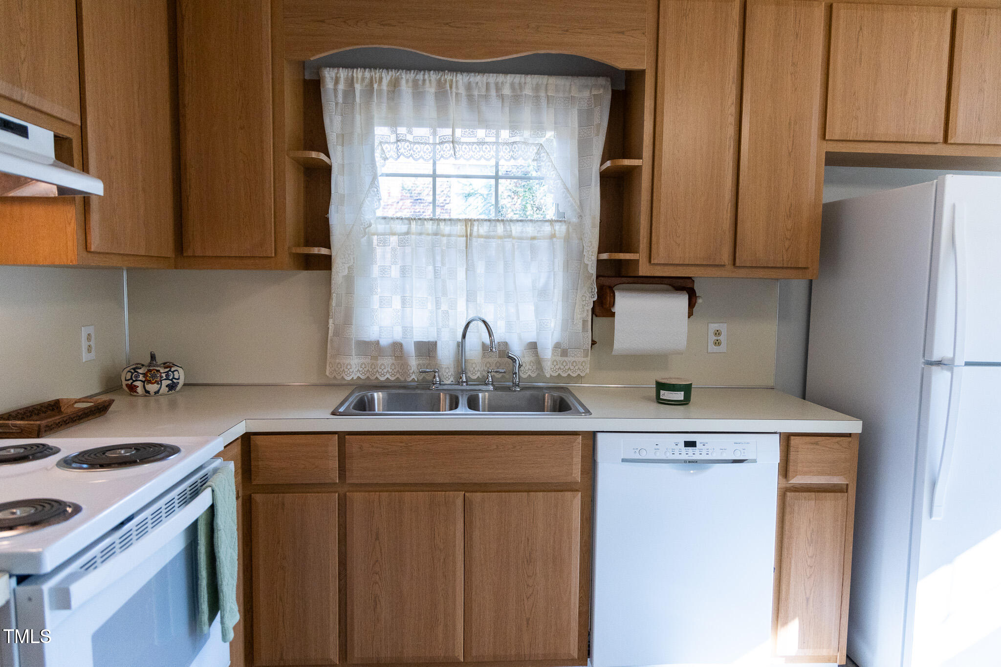 3212 Sparger Road Durham, NC 27705 - Photo 14 of 57 a kitchen with a sink a stove cabinets and a window