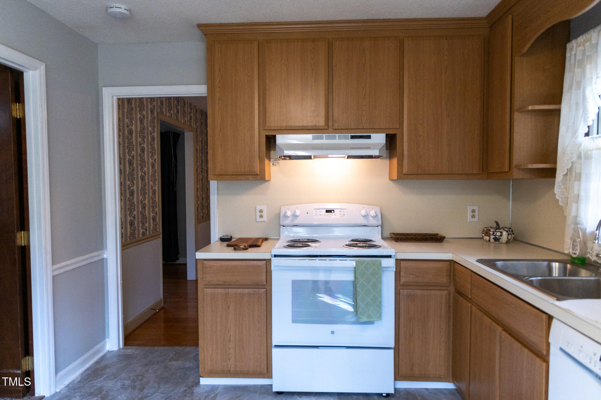 3212 Sparger Road Durham, NC 27705 - Photo 15 of 57 a kitchen with a stove top oven sink and cabinets