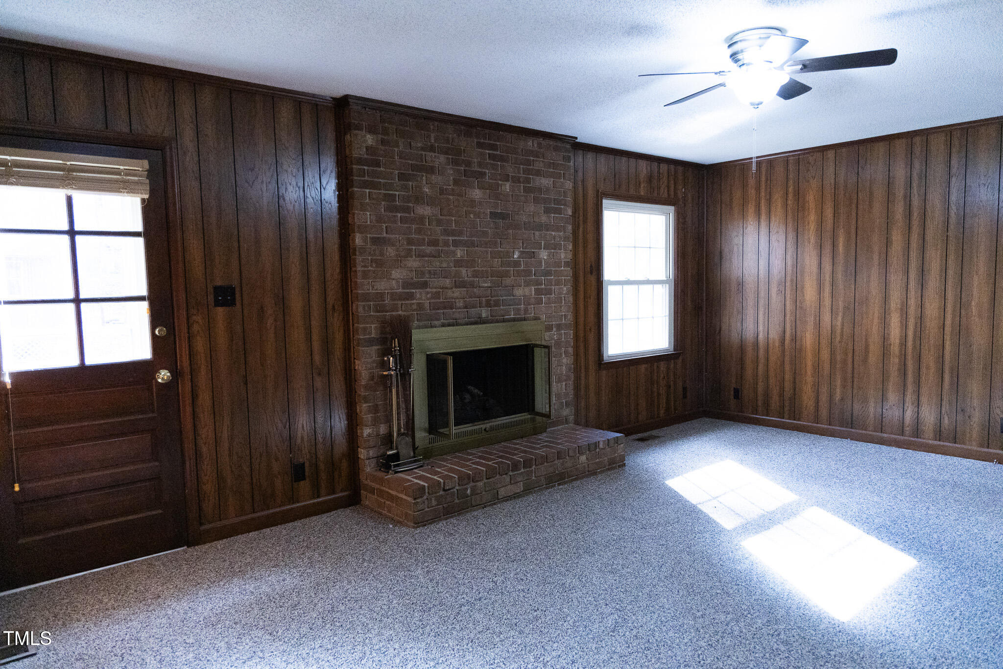 3212 Sparger Road Durham, NC 27705 - Photo 24 of 57 wooden floor fireplace and windows in an empty room
